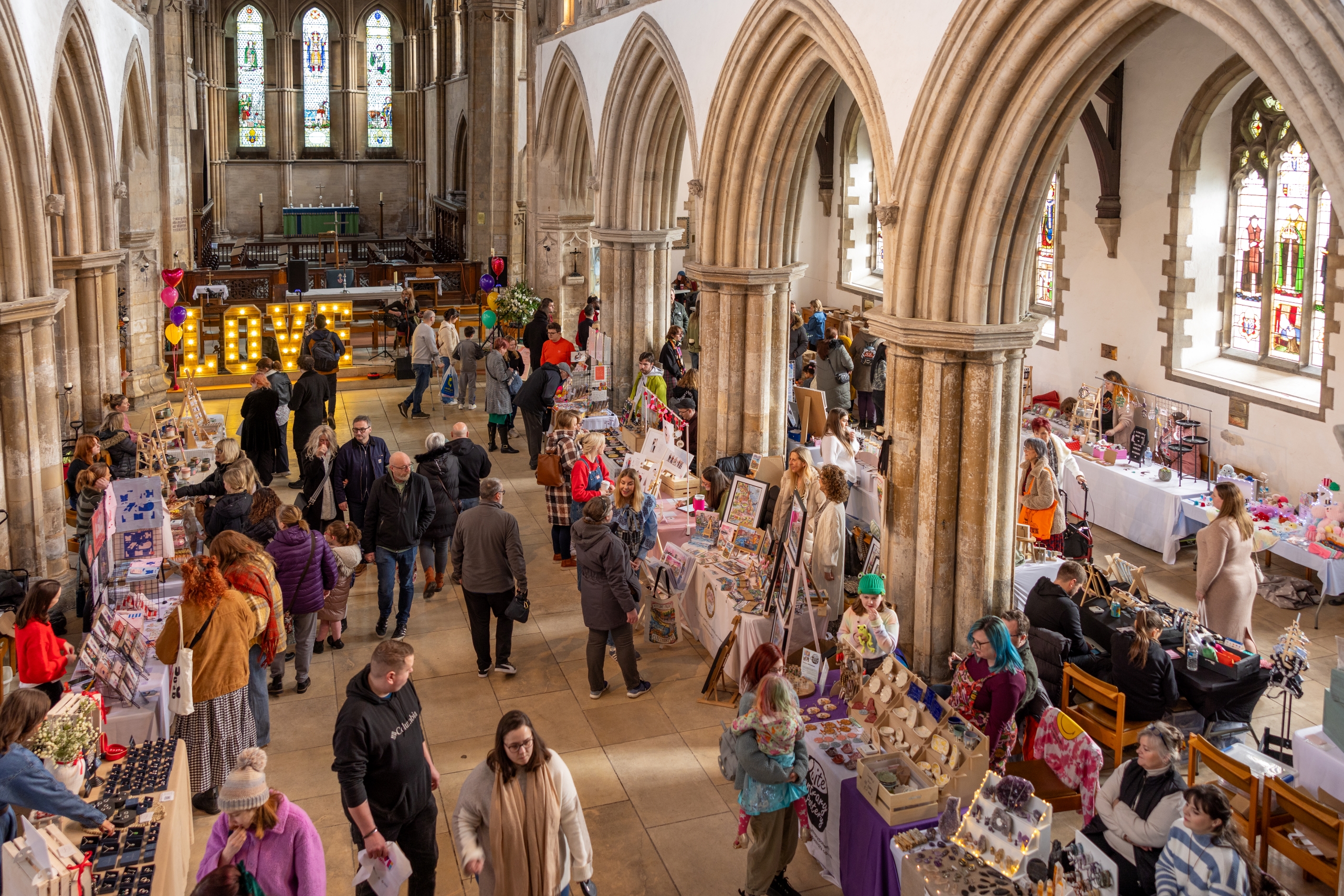 Makers Market in Grimsby Minster with people browsing stalls