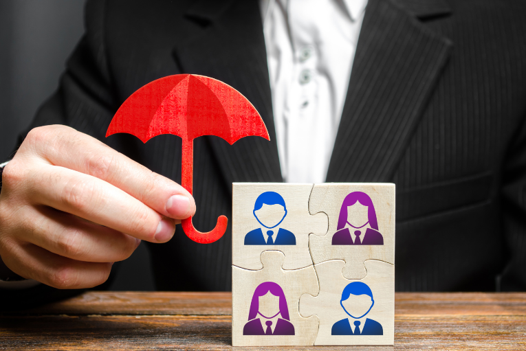 a person in a suit is holding a puzzle piece with a red umbrella over it